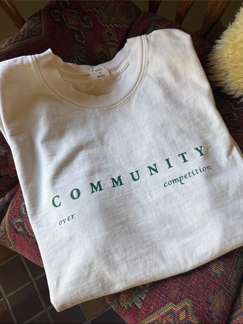 Less Is More “Community Over Competition” Tee — Cotton